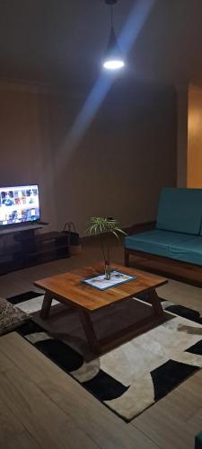 a living room with a coffee table and a couch at Hillside Inn lubowa in Kampala