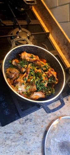 a pan of food on top of a stove at Hillside Inn lubowa in Kampala