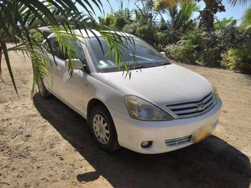 a white car parked on the ground next to a palm tree at Apt 4 Great Mountain Views In Nadi , My Ecolodge in Nadi