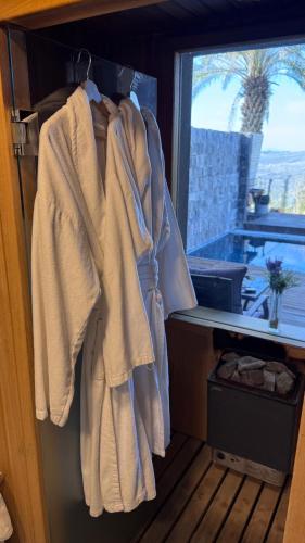 a room with towels hanging on a door with a window at Diamond Mansion-Suite A in Had Nes