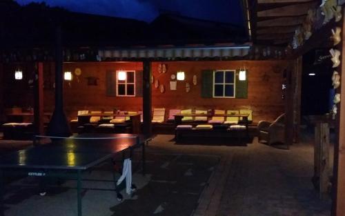 a patio with couches and tables at night at Appartements Schmidsendl in Lofer