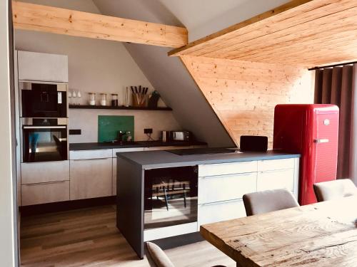 a kitchen with a red refrigerator and a table at FourElements in Wernigerode
