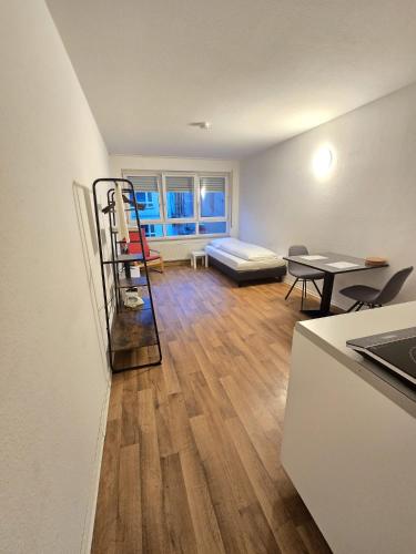 a living room with a ladder and a couch at Apartments EFDE Boardinghouse Heilbronn in Heilbronn