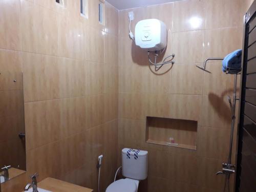 a bathroom with a toilet and a sink and a mirror at Ahza syariah in Rantauprapat