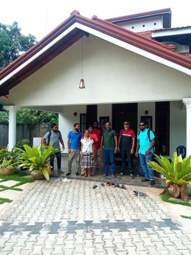 a group of people standing in front of a house at Marigold Negombo in Negombo