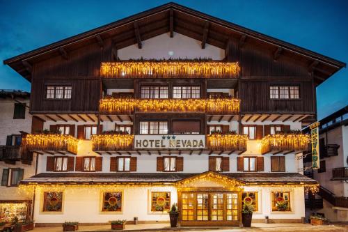a hotel with lights on the front of a building at Best Western Hotel Nevada in San Vito di Cadore