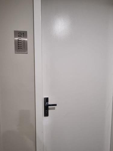 a white door with a lock on it at Modern 1 Bedroom apartment with Pool, Gym & Water Views in Belconnen