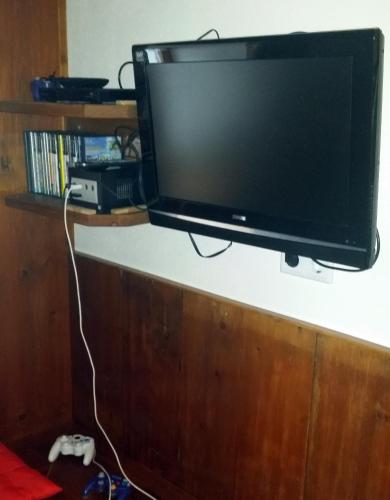a flat screen tv hanging on a wall at Appartements Schmidsendl in Lofer