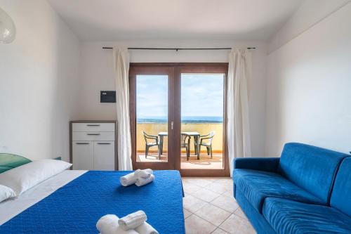 En eller flere senge i et værelse på Residence Il Borgo di Badesi