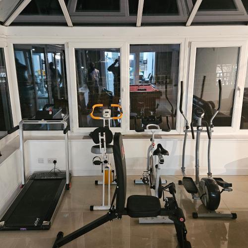 a gym with several exercise bikes and a window at Vancouver Place in Orpington