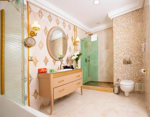 a bathroom with a shower and a sink and a toilet at Grand Makel Hotel Topkapi in Istanbul
