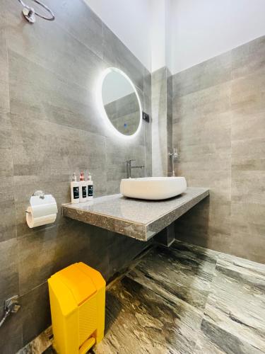 a bathroom with a sink and a mirror at Kingsman Villa in Mirissa