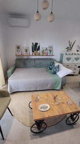 a bedroom with a bed and a coffee table at Villa Filothea with Jacuzzi and sea view in Spartýlas