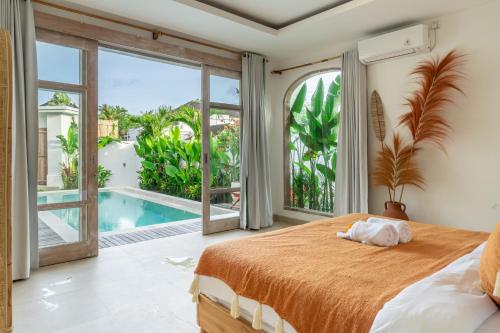 a bedroom with a bed and a pool at Bambola - Stunning New Luxury Villa in Kerobokan with Expansive Pool - Your Dream Home Awaits! in Canggu