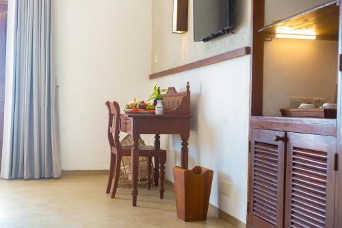 a kitchen with a table with a bowl of fruit on it at Dickwella Resort and Spa in Dickwella