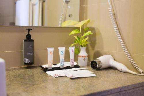 a bathroom counter with toothbrushes and other items on it at Dickwella Resort and Spa in Dickwella