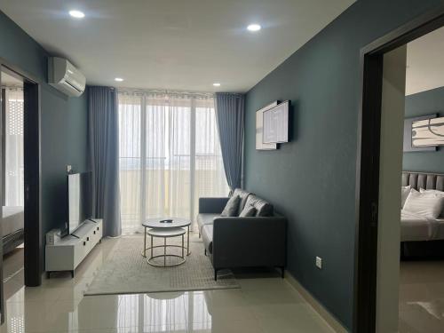 a living room with a couch and a bed at The PeAk Residence, Multi-Apartment by Emma in Phnom Penh