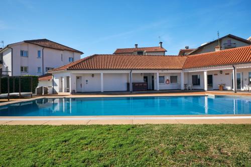 a swimming pool in front of a house at A Casa Branca - with Pool & Jacuzzi in Santa Comba Dão