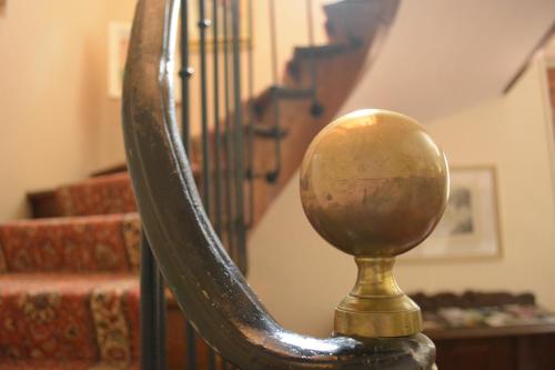 a close up of a metal stair railing with a ball at Manoir Bonpassage in Thury