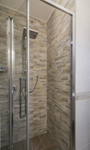 a shower with a glass door in a bathroom at Villa Lazzari B&B Tra i due Mari in Maglie