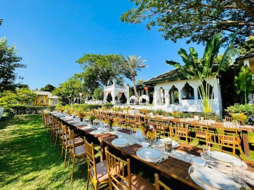 a long table set up for a wedding in a garden at The Cathay Resort & Spa in Chiang Mai