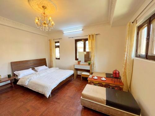 a bedroom with a bed and a chandelier at Nakhu Nest in Pātan