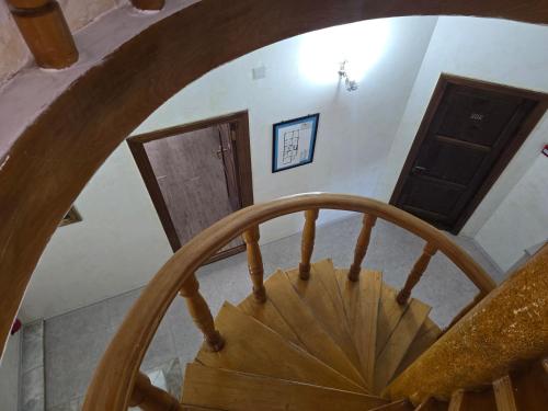 a wooden spiral staircase in a house at Hotel Cattaleya in Batumi