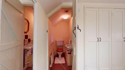 ein kleines Badezimmer mit Toilette und Waschbecken in der Unterkunft Hannah Cottage in Adderbury