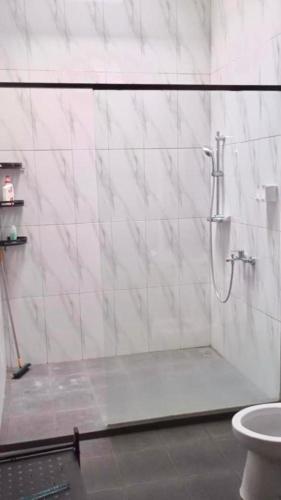 a bathroom with a shower and a toilet at Rumah 5KT Sby Brt dkt Kidzania in Surabaya