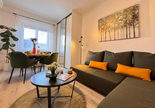 a living room with a couch and a table at CityLink Nest Budapest - Free garage, AC & metro access in Budapest