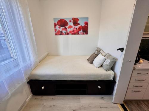 a small bed in a room with a window at CityLink Nest Budapest - Free garage, AC & metro access in Budapest
