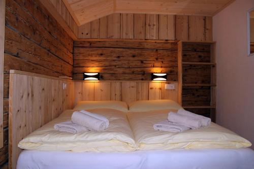a large white bed with two pillows in a room at Appartements Schmidsendl in Lofer
