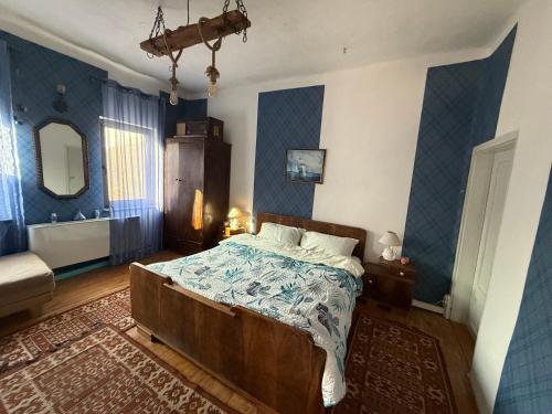 a bedroom with a bed and a bathroom with a mirror at Къща За Гости Двата Ореха in Protopopintsi