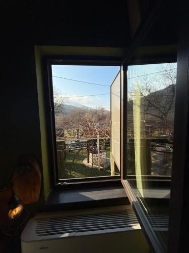 a window in a room with a view at Къща За Гости Двата Ореха in Protopopintsi