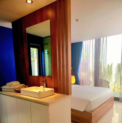 a bathroom with a sink and a large mirror at Beach Oceanami Villa in Long Hai