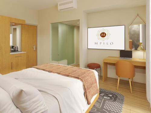 a bedroom with a bed and a desk with a laptop at Mpilo Boutique Hotel in Maseru