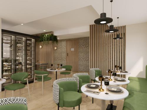 a dining room with tables and green chairs at Mpilo Boutique Hotel in Maseru