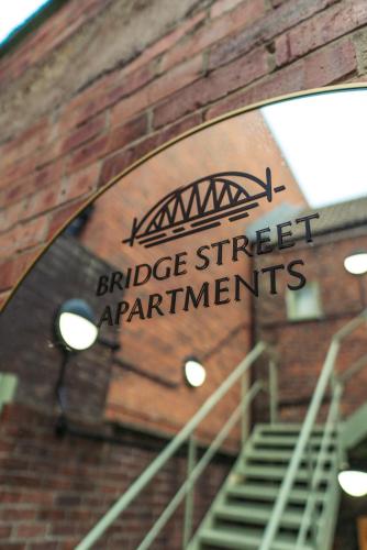 a sign on the side of a brick building at Town Centre Apartments with Spa in Morpeth