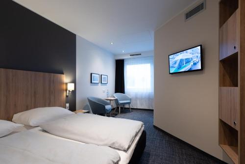 Ένα ή περισσότερα κρεβάτια σε δωμάτιο στο Egon Hotel Hamburg City