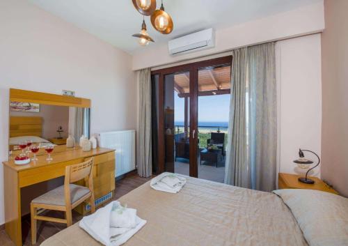 a bedroom with a desk and a bed and a desk and a desk at Marilia by Vintage Travel in Maleme
