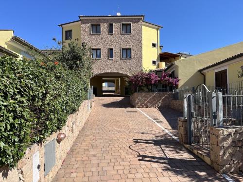 a brick walkway in front of a building at Villa Sole e Luna - Key to Villas in Valledoria