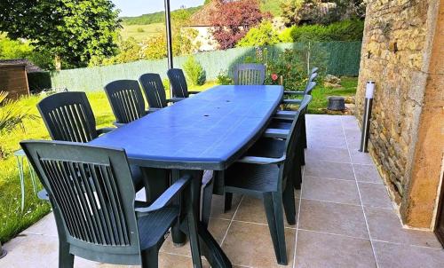 a blue table and chairs on a patio at La GRANGE D'AZE in Azé