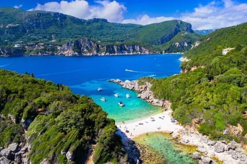 an aerial view of a beach with people in the water at Traditional two level Apartment in Liapades