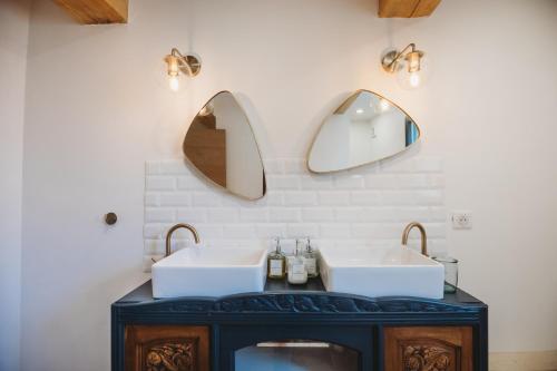 une salle de bain avec deux lavabos et deux miroirs dans l'établissement Mas des Ecoliers - Ecochic family farmhouse, à Châteaurenard