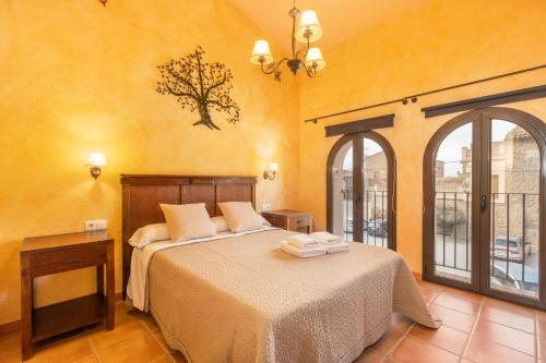 a bedroom with a bed and a large window at Cal Emilia in Ossó de Sió