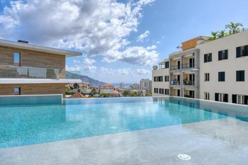 a swimming pool in the middle of a building at The Queen Apartment By Sam Houses in Funchal