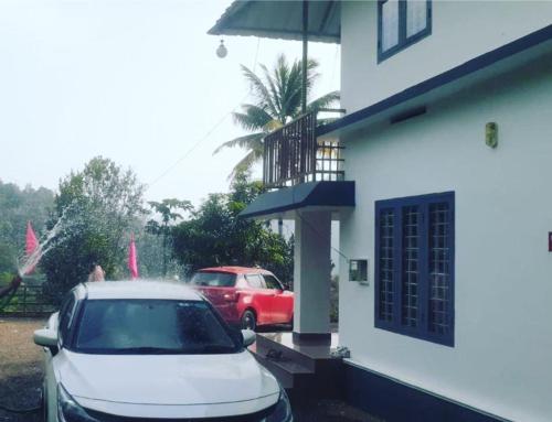 a white car parked in front of a building at Oasis villa in Vagamon