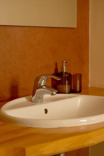 a bathroom sink with a faucet on a counter at Sammit holiday home in Michelica