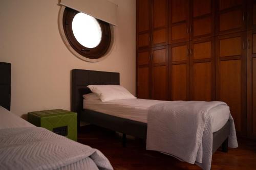 a small bedroom with a bed and a window at Sammit holiday home in Michelica