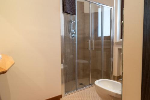 a bathroom with a glass shower and a sink at Sammit holiday home in Michelica